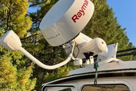 Slide: The Image of 2007 C-Dory Tomcat 255 Pilothouse with Raymarine radar, surrounded by trees. - 8