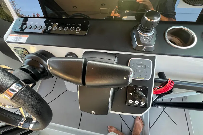 Slide: The Image of Control panel of 2023 Saxdor 320 GTO boat with steering wheel and throttle. - 28