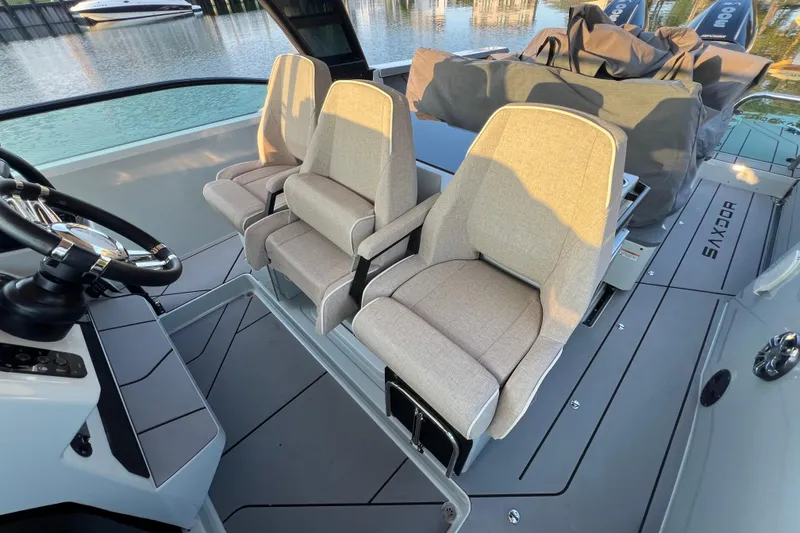 Slide: The Image of 2023 Saxdor 320 GTO interior with modern seating and steering wheel, docked by water. - 31