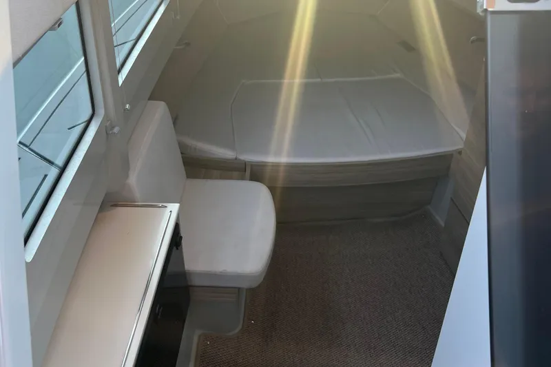 Slide: The Image of Interior cabin of 2023 Saxdor 320 GTO boat with seating and sunlight streaming in. - 39
