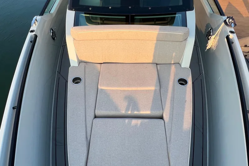 Slide: The Image of 2023 Saxdor 320 GTO boat with beige cushioned seating and cup holders on deck. - 43