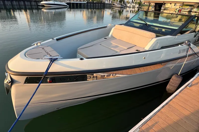 Slide: The Image of 2023 Saxdor 320 GTO boat docked in a marina, sleek design and modern features. - 47