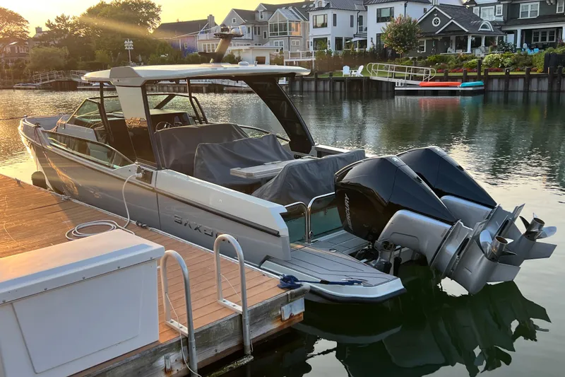 Slide: The Image of 2023 Saxdor 320 GTO docked by waterfront homes at sunset. - 49