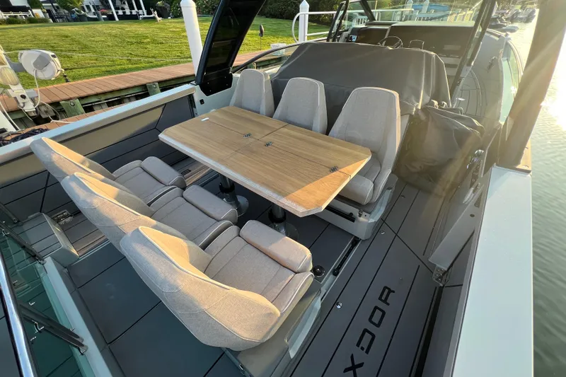 Slide: The Image of 2023 Saxdor 320 GTO boat interior with seating and wooden table. - 9