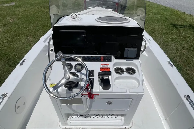 Slide: The Image of 2019 Sea Hunt BX 20 BR boat console with steering wheel and controls. - 10