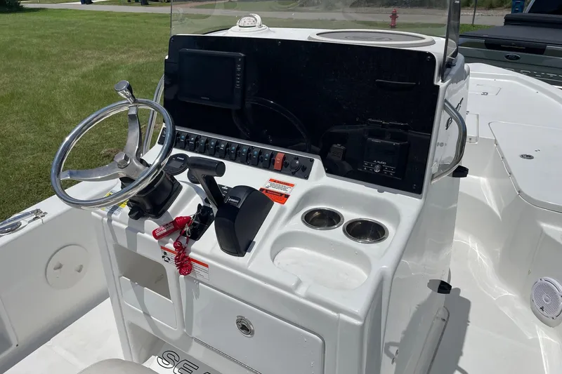 Slide: The Image of 2019 Sea Hunt BX 20 BR boat console with steering wheel, controls, and cup holders. - 11