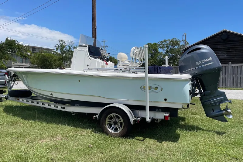 Slide: The Image of 2019 Sea Hunt BX 20 BR boat on trailer with Yamaha outboard motor, parked on grass. - 2