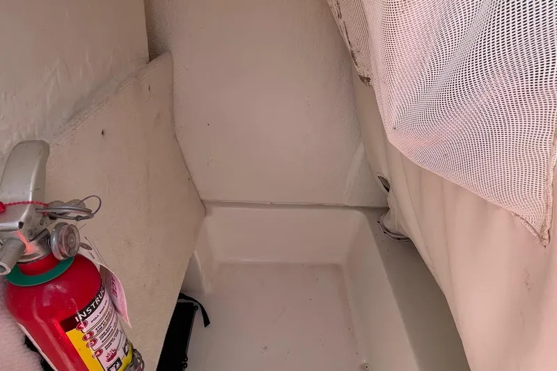 Slide: The Image of 2019 Sea Hunt BX 20 BR interior with fire extinguisher and storage netting. - 27