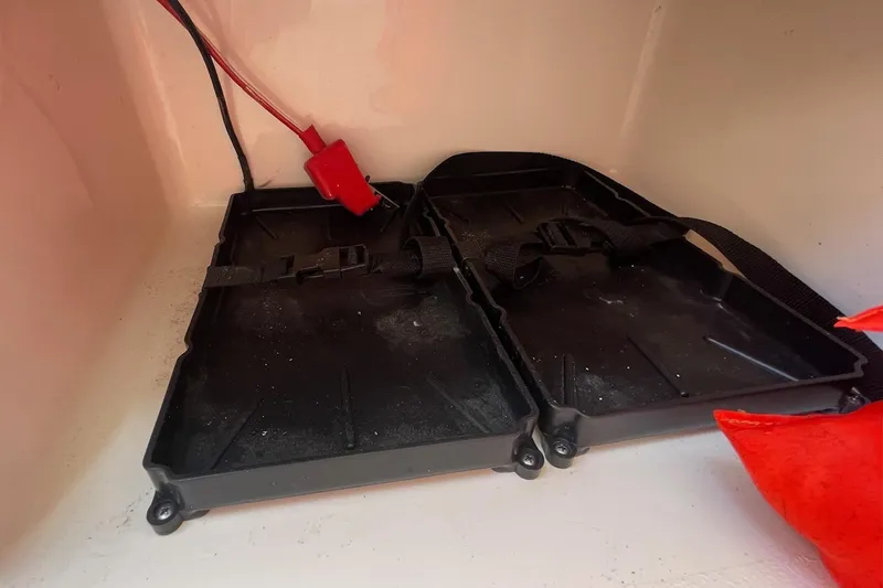 Slide: The Image of Battery compartment of a 2019 Sea Hunt BX 20 BR boat with red cables. - 29