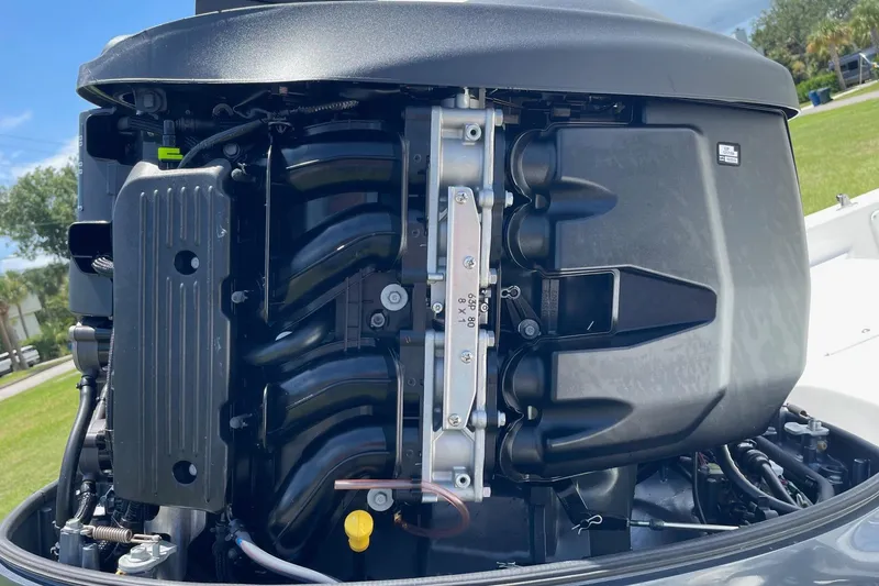 Slide: The Image of Close-up of a 2019 Sea Hunt BX 20 BR boat engine, showcasing intricate mechanical details. - 37