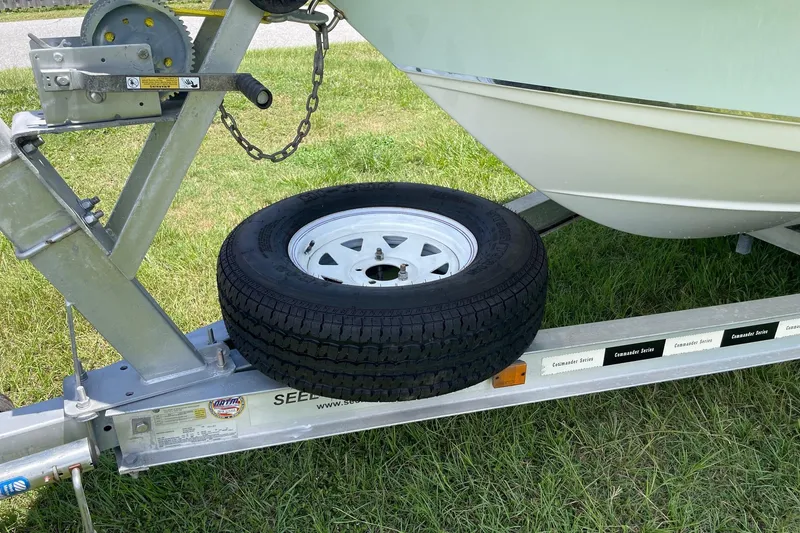 Slide: The Image of Trailer with spare tire for 2019 Sea Hunt BX 20 BR boat on grass. - 39