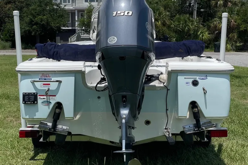 Slide: The Image of 2019 Sea Hunt BX 20 BR boat with Yamaha 150 outboard motor, parked on grass. - 5