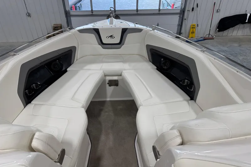 Slide: The Image of Interior of a 2012 Monterey 328 SS Axius boat with white seating. - 11