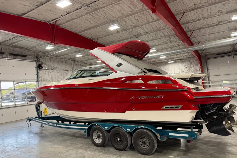Slide: The Image of Red 2012 Monterey 328 SS Axius boat on trailer in a garage. - 3