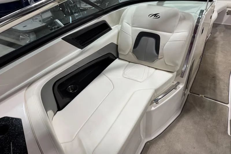 Slide: The Image of 2012 Monterey 328 SS Axius boat interior with white seating and cup holder. - 7