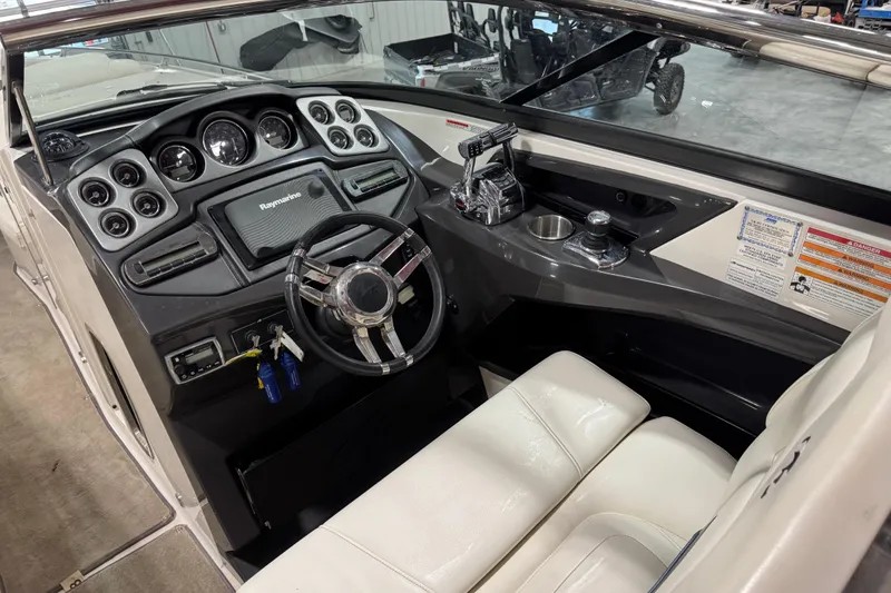 Slide: The Image of 2012 Monterey 328 SS Axius boat cockpit with steering wheel and control panel. - 8