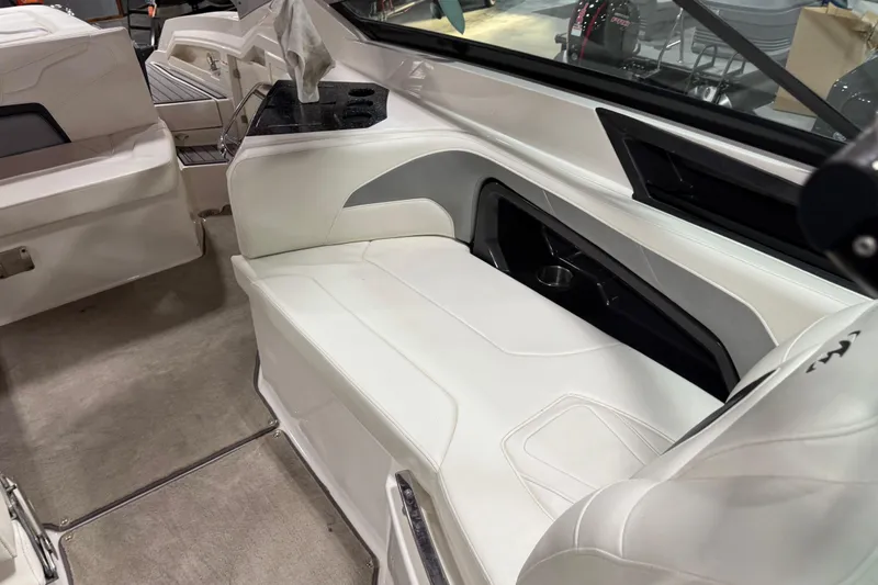 Slide: The Image of Interior of a 2012 Monterey 328 SS Axius boat with white seating and cup holders. - 9