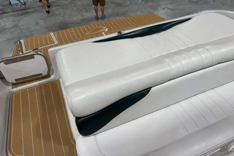 Slide: The Image of 2001 Crownline 288 BR boat with white and green seating on a wooden deck. - 13
