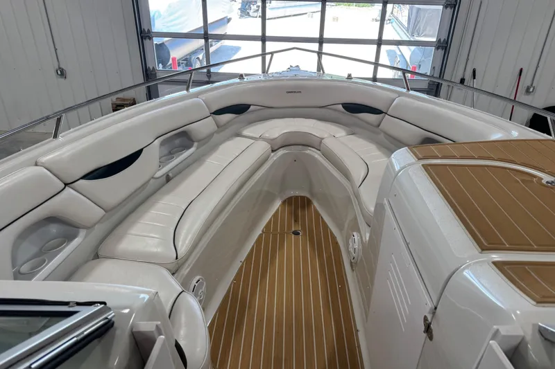 Slide: The Image of 2001 Crownline 288 BR boat interior with white seating and wood flooring. - 14