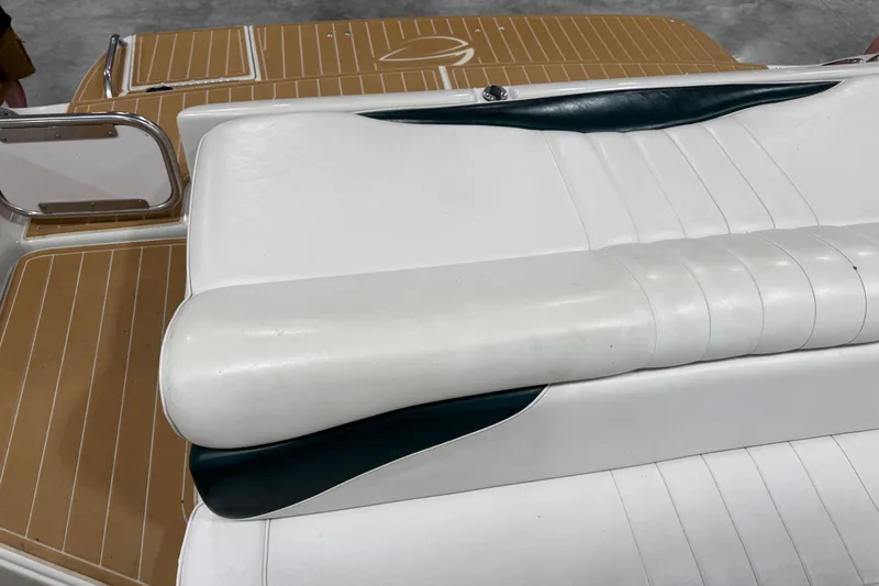 Slide: The Image of White leather seating on 2001 Crownline 288 BR boat, featuring sleek design and wood-patterned flooring. - 9