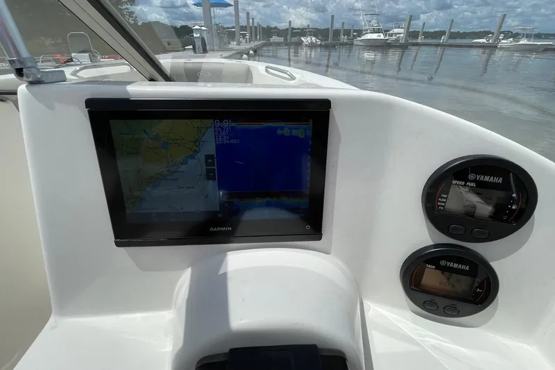 Slide: The Image of Dashboard of 2023 Key West 203 DFS boat with Garmin navigation and Yamaha gauges. - 12