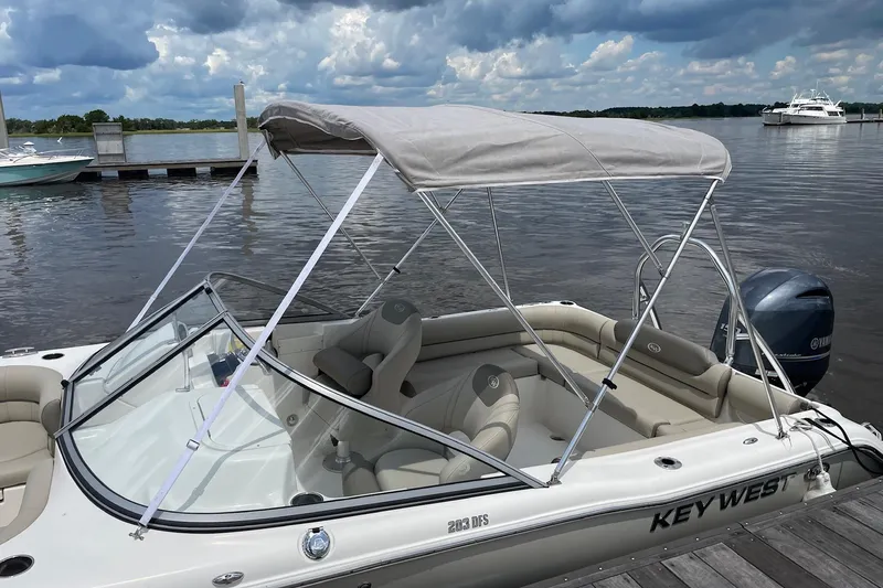 Slide: The Image of 2023 Key West 203 DFS boat docked, featuring a canopy and Yamaha outboard motor. - 18
