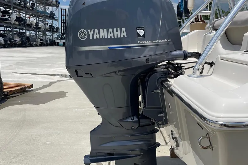 Slide: The Image of 2023 Key West 203 DFS boat with Yamaha four-stroke outboard motor in marina setting. - 28