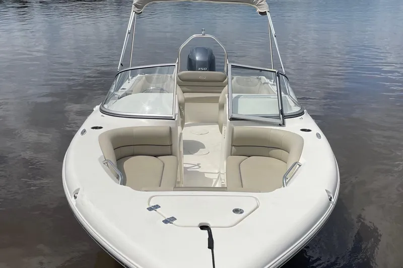 Slide: The Image of 2023 Key West 203 DFS boat on calm water, featuring spacious seating and sleek design. - 4