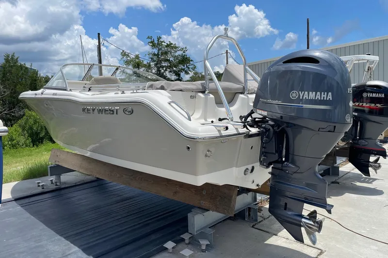 Slide: The Image of 2023 Key West 203 DFS boat with Yamaha engine on display outdoors. - 5