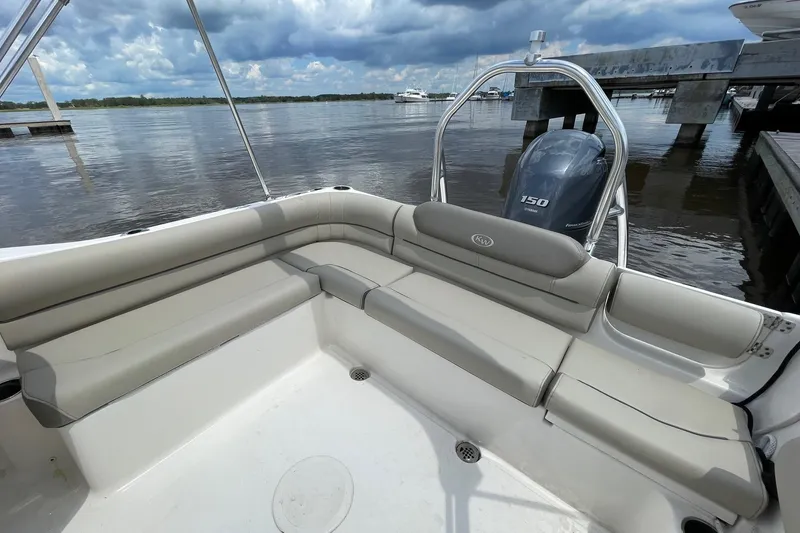 Slide: The Image of 2023 Key West 203 DFS boat interior with cushioned seating and Yamaha 150 engine. - 8