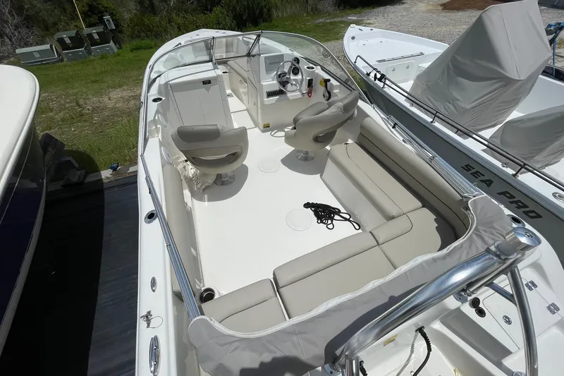 Slide: The Image of 2023 Key West 203 DFS boat interior with seating and steering console. - 9