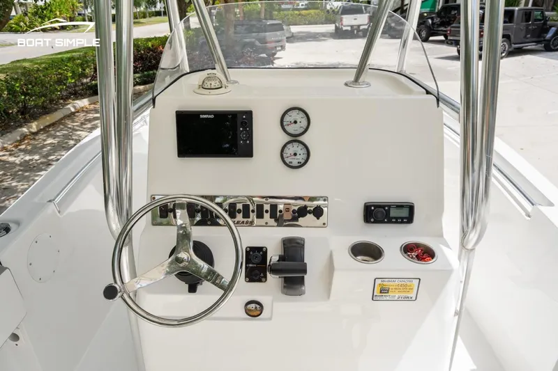 Slide: The Image of Center console of 2020 Release 210 RX boat with steering wheel and gauges. - 12