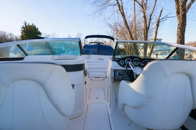 Slide: The Image of 2015 Sea Ray 220 Sundeck interior with white seating and dashboard view. - 5