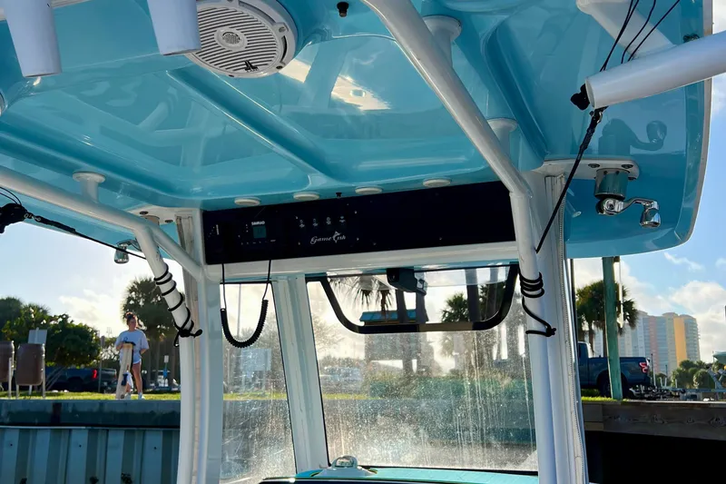 Slide: The Image of 2019 Sea Hunt 27 Gamefish CC boat interior with blue ceiling and fishing equipment. - 10