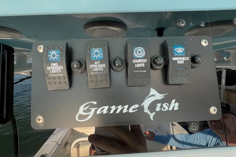 Slide: The Image of Control panel of a 2019 Sea Hunt 27 Gamefish CC boat with labeled switches. - 12