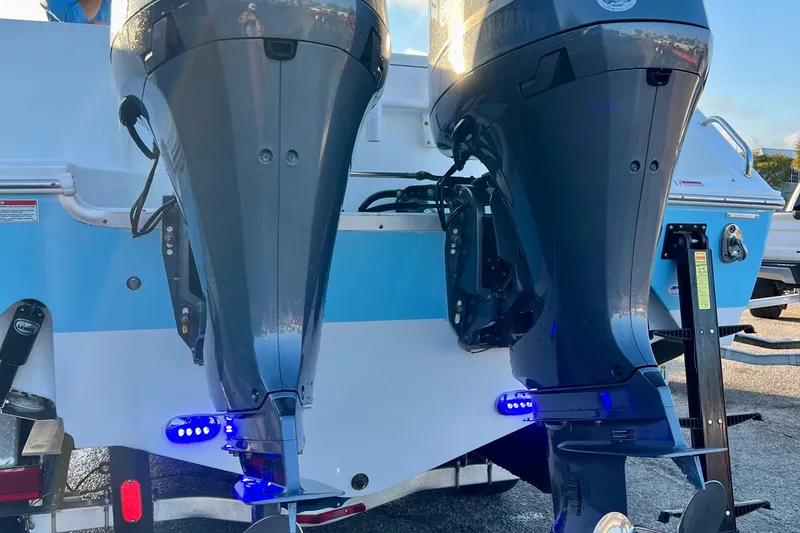 Slide: The Image of 2019 Sea Hunt 27 Gamefish CC with dual outboard motors and blue LED lights. - 15