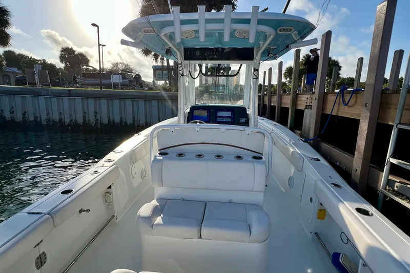 Slide: The Image of 2019 Sea Hunt 27 Gamefish CC boat docked, featuring spacious seating and modern controls. - 3
