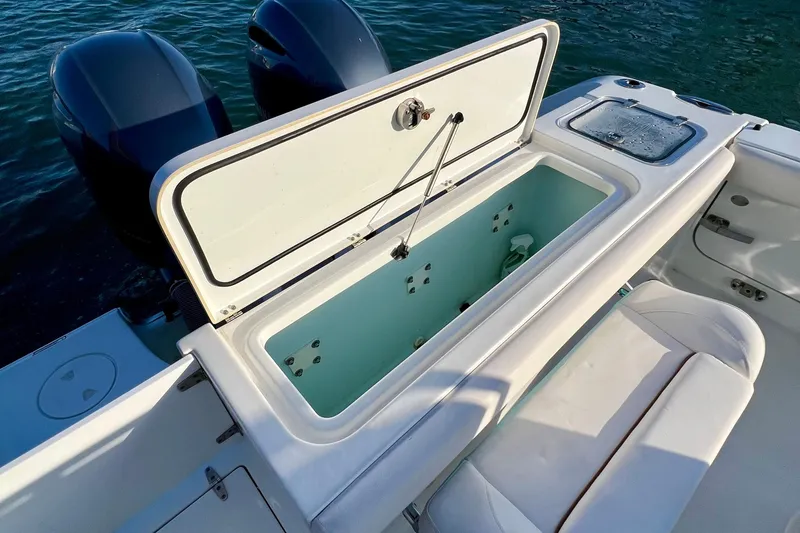 Slide: The Image of 2019 Sea Hunt 27 Gamefish CC boat with open storage compartment and dual engines. - 4
