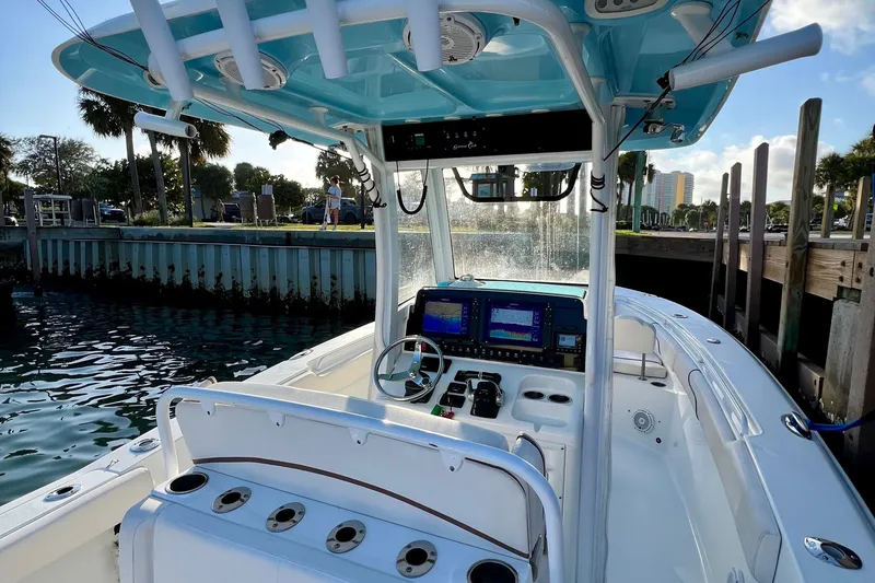 Slide: The Image of 2019 Sea Hunt 27 Gamefish CC boat with modern dashboard and fishing rod holders. - 8