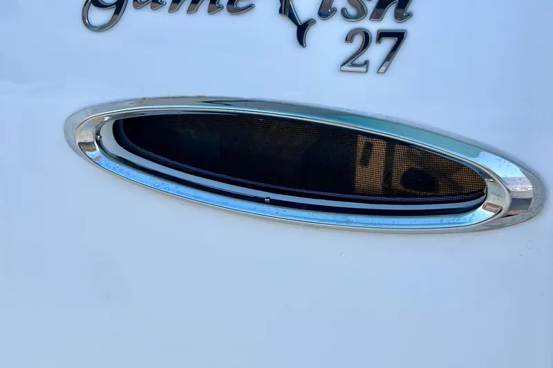 Slide: The Image of 2019 Sea Hunt 27 Gamefish CC boat detail with chrome trim and model name. - 9