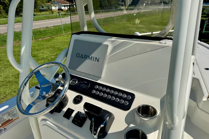 Slide: The Image of 2024 Skeeter SX 241 boat dashboard with Garmin navigation system and steering wheel. - 12