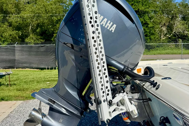 Slide: The Image of 2024 Skeeter SX 241 boat with Yamaha outboard motor, parked on gravel near green grass. - 4