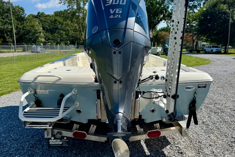 Slide: The Image of 2024 Skeeter SX 241 boat with powerful V6 engine, parked on gravel. - 5