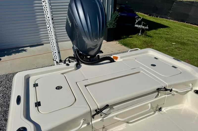 Slide: The Image of 2024 Skeeter SX 241 boat with Yamaha outboard motor, docked on concrete and grass. - 9