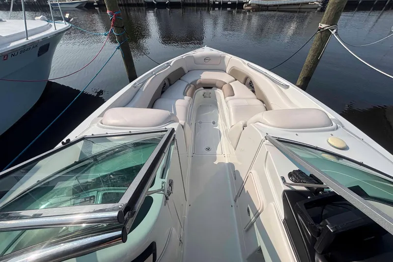 Slide: The Image of 2014 Crownline 285 SS boat with spacious seating, docked at marina. - 12