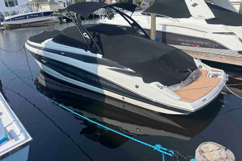 Slide: The Image of 2014 Crownline 285 SS boat docked with black cover and canopy. - 14