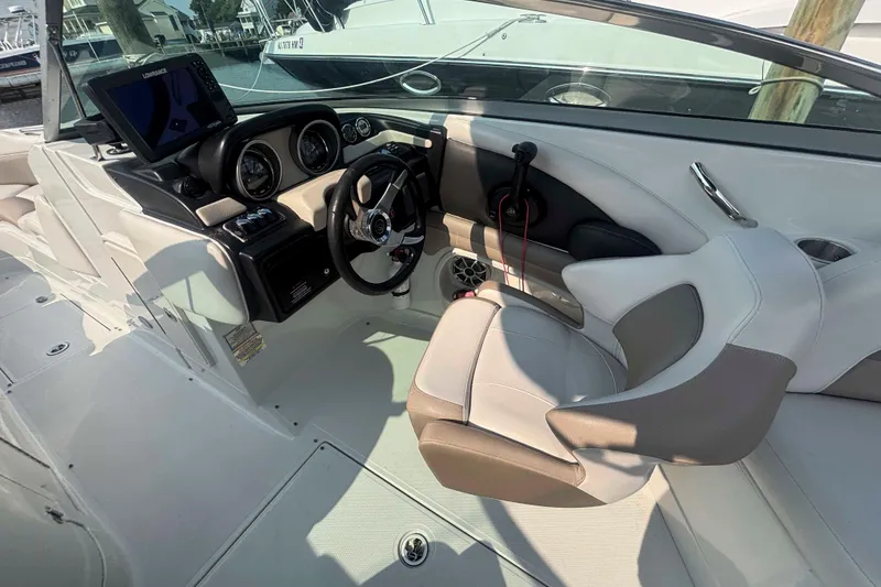 Slide: The Image of 2014 Crownline 285 SS boat cockpit with steering wheel and control panel. - 4