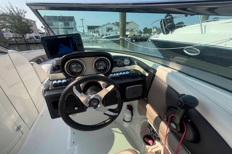 Slide: The Image of 2014 Crownline 285 SS boat dashboard with steering wheel and navigation system. - 5