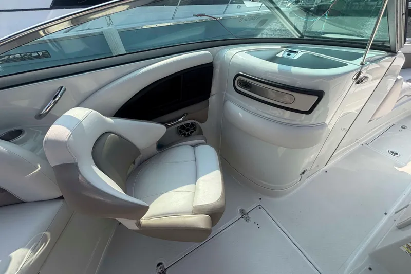 Slide: The Image of Interior of a 2014 Crownline 285 SS boat, featuring sleek white seating and modern design. - 7