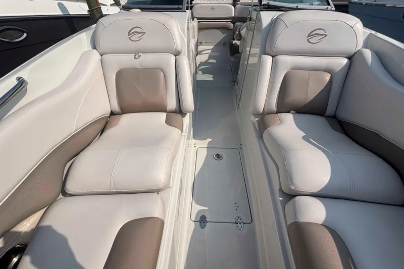 Slide: The Image of 2014 Crownline 285 SS boat interior with beige and brown seating. - 8